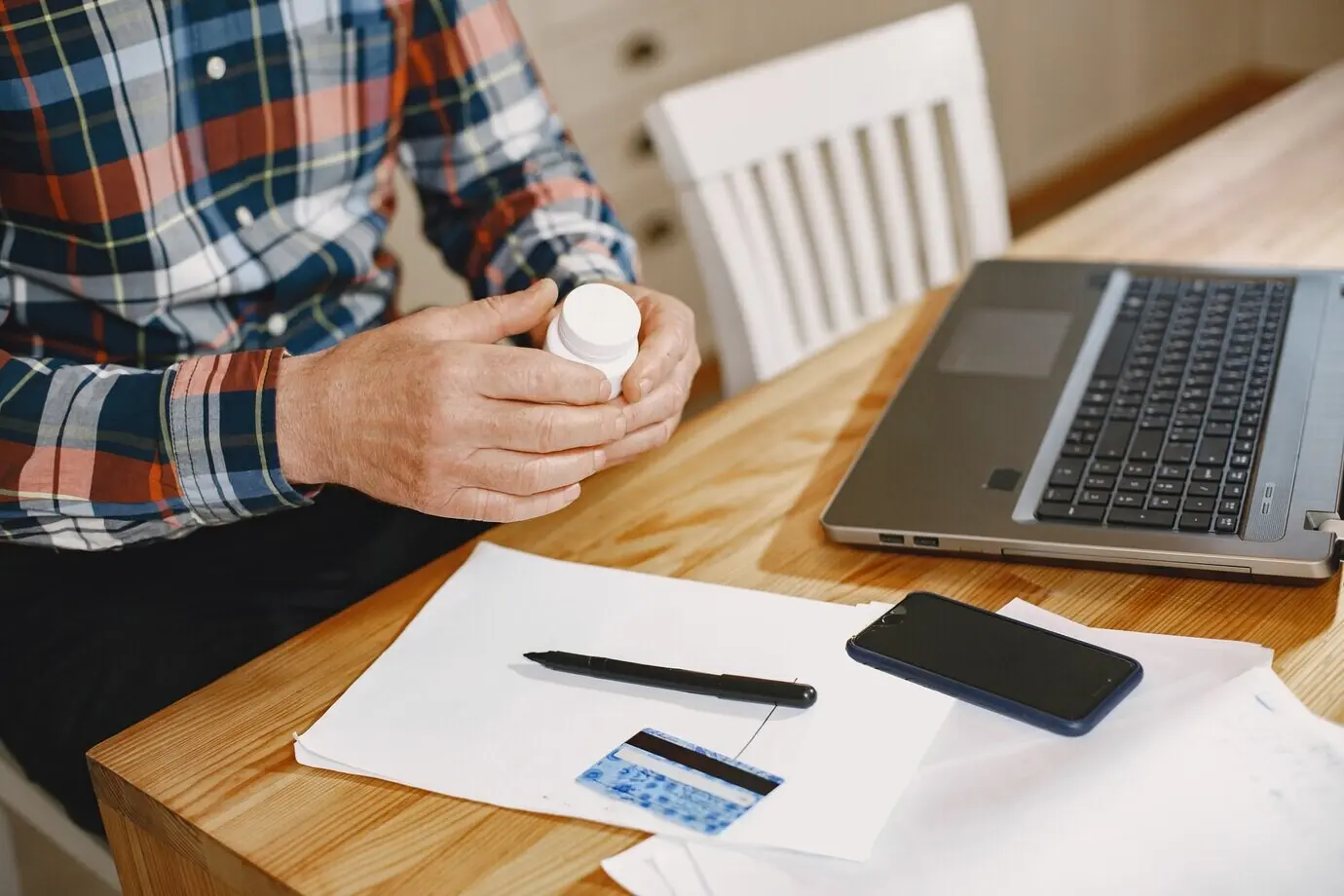 An elderly man with a laptop.